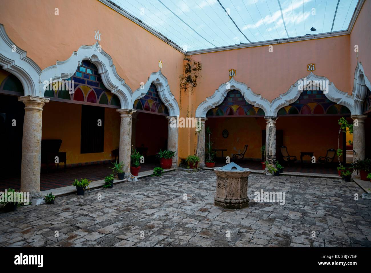 Orange colored courtyard of an ancient colonial house with arched ...