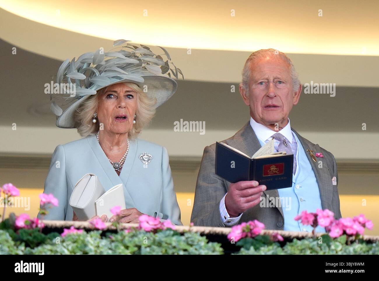 Queen Camilla and King Charles III watch the Coventry Stakes during day ...