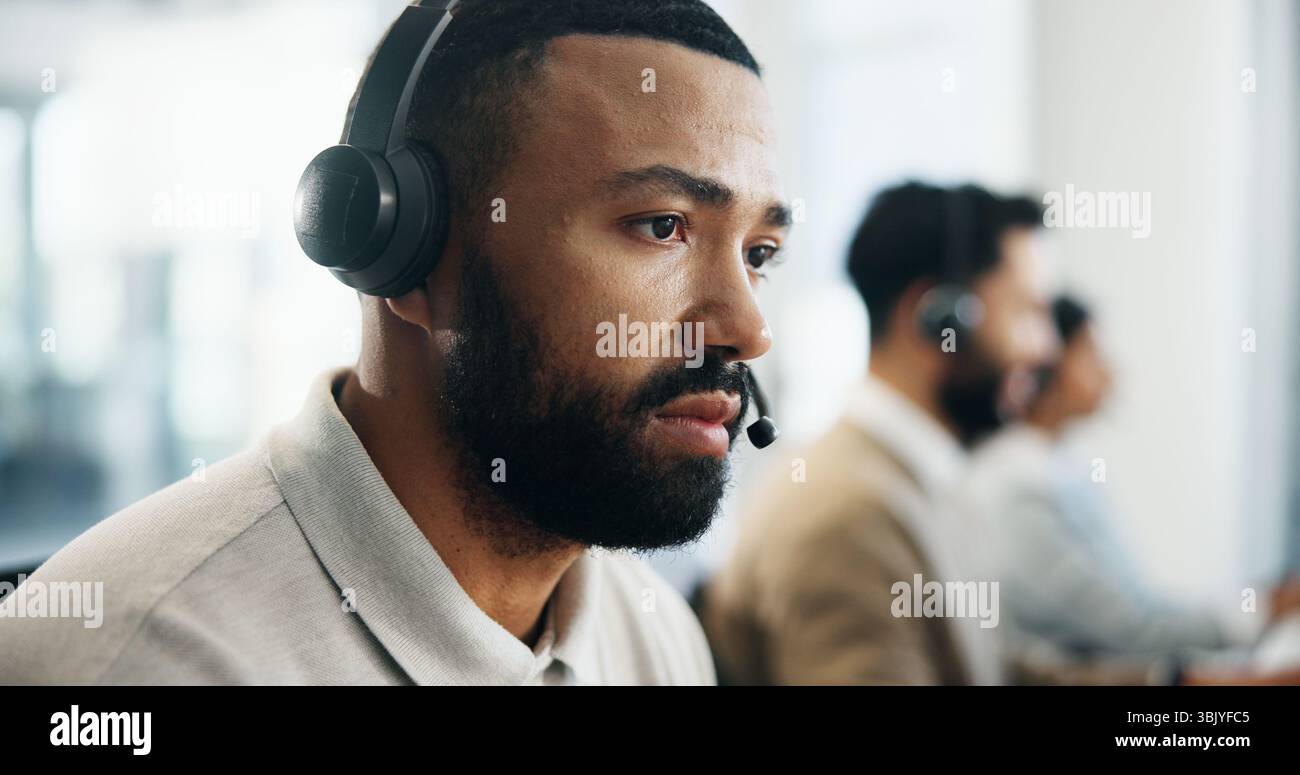 Serious, profile and man in call center for technical support, IT solution or coworking. Headset, problem solving and operator think of virtual Stock Photo