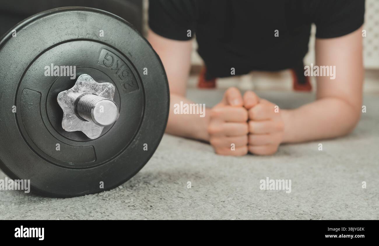 Man doing plank exercise. Home fitness training concept. Stock Photo