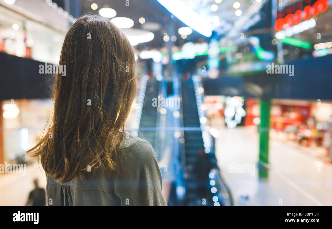 Girl in lift in a large shopping center. Stock Photo