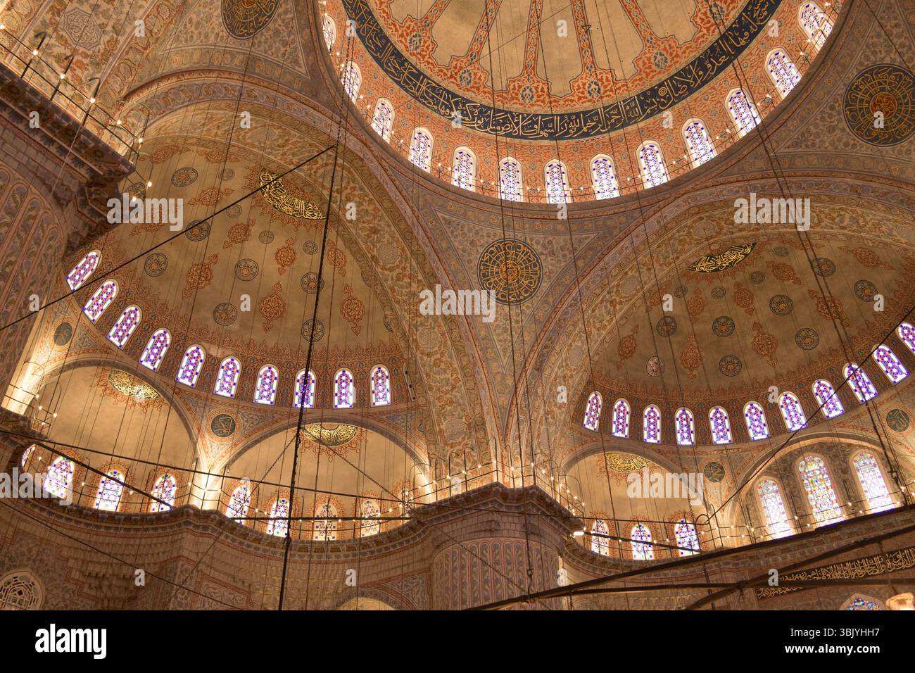 Visitors admire the remarkable details of ornate ceilings and stained ...