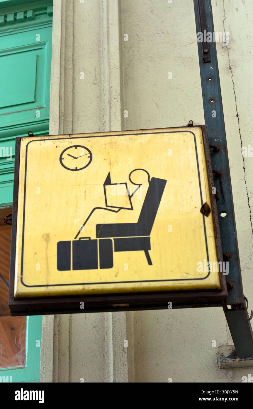Wait Sit Sit and wait sign in a train station Stock Photo - Alamy