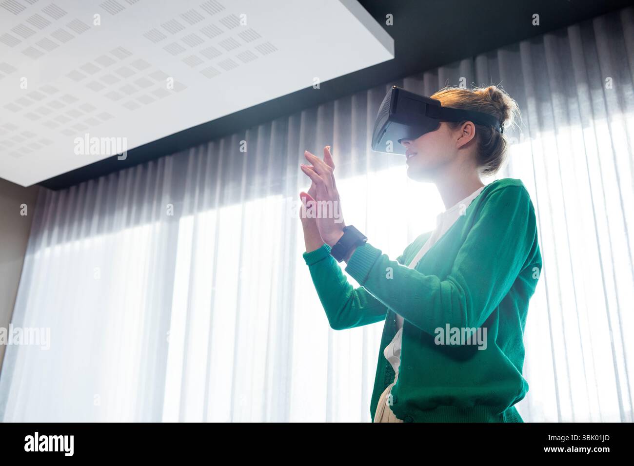 Woman wearing VR headset, smartwatch interacting with virtual interface ...