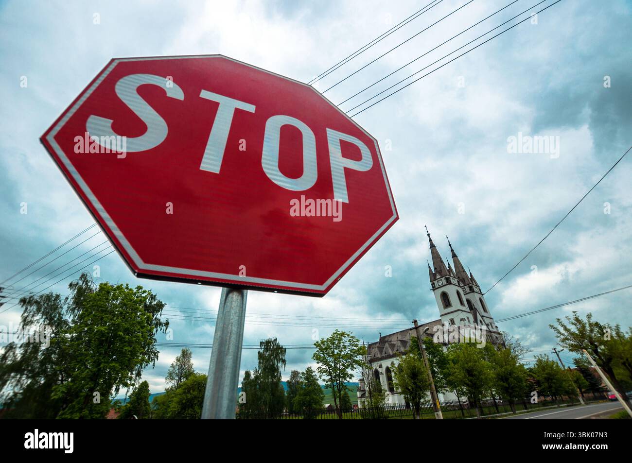 Red stop sign with church in the background hi-res stock photography ...