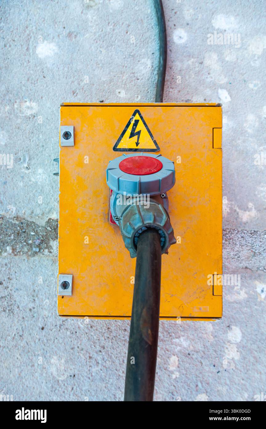 Electrical box with a high-voltage cable connected to it. Stock Photo