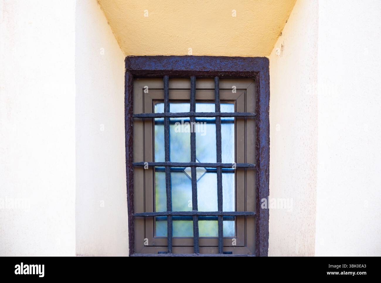 Window with rusty bars in an old building, close-up. Stock Photo