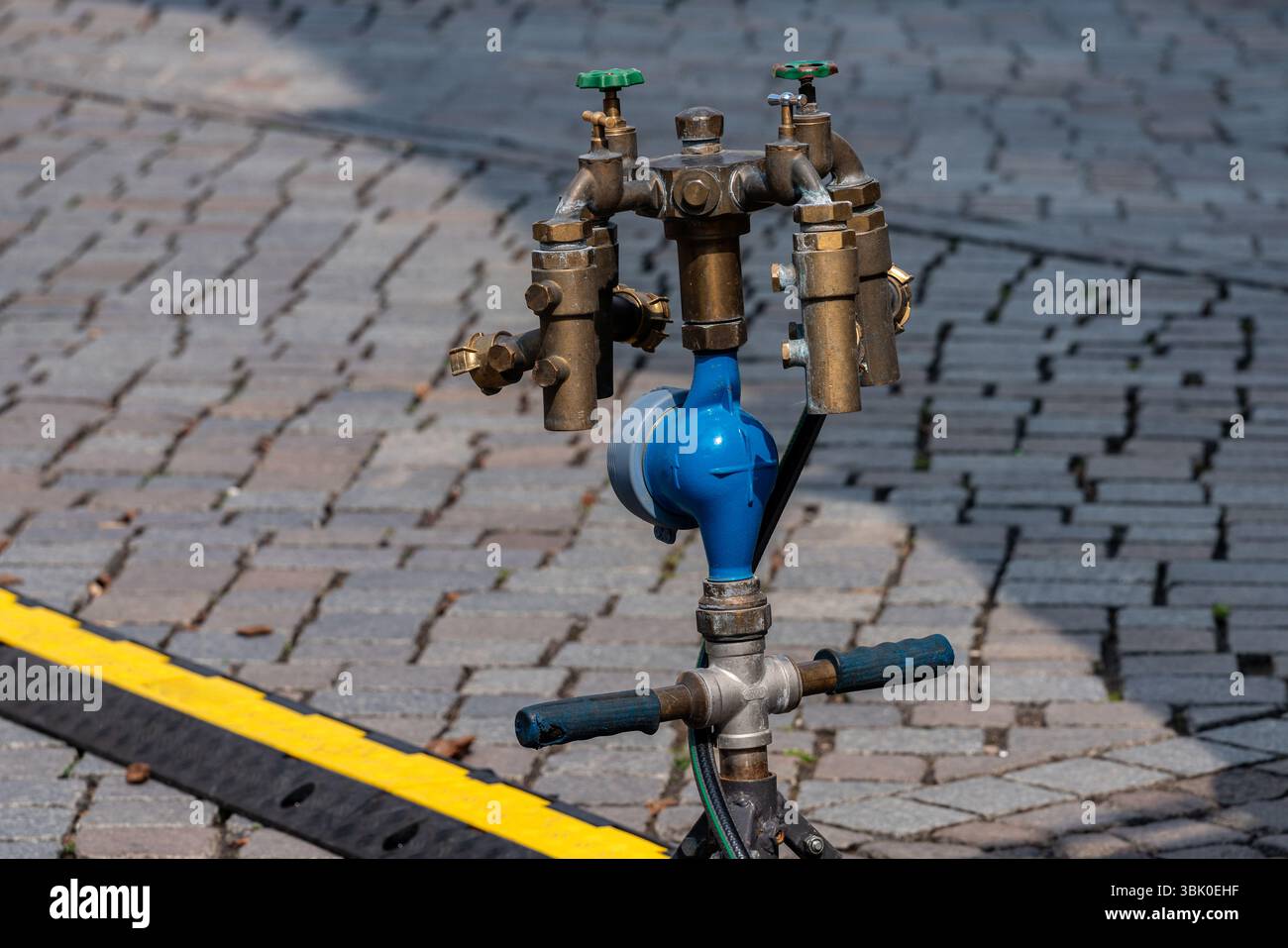 A complex water supply system featuring multiple brass valves and a ...