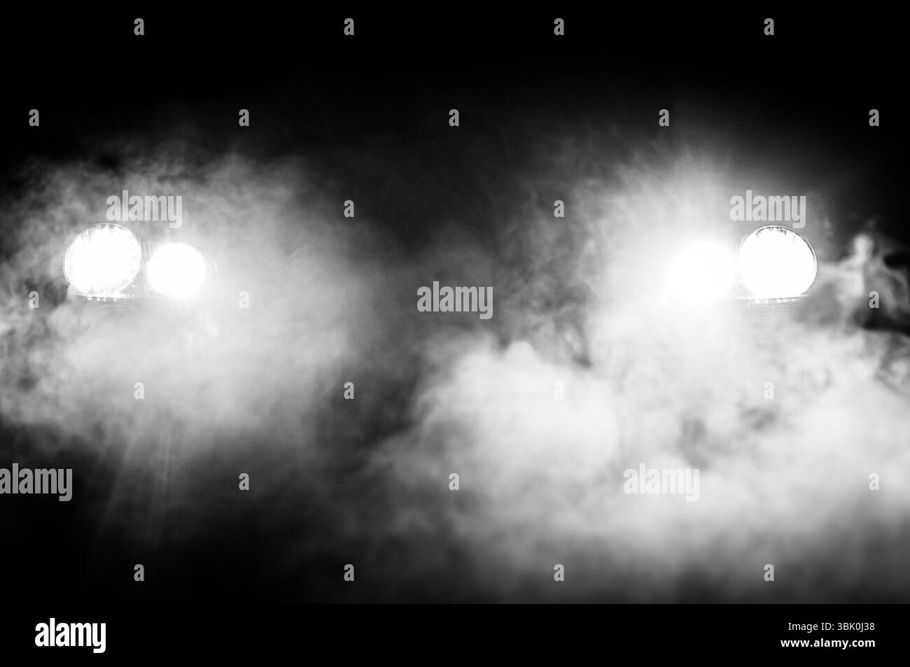 Car Headlights of a car at night Stock Photo