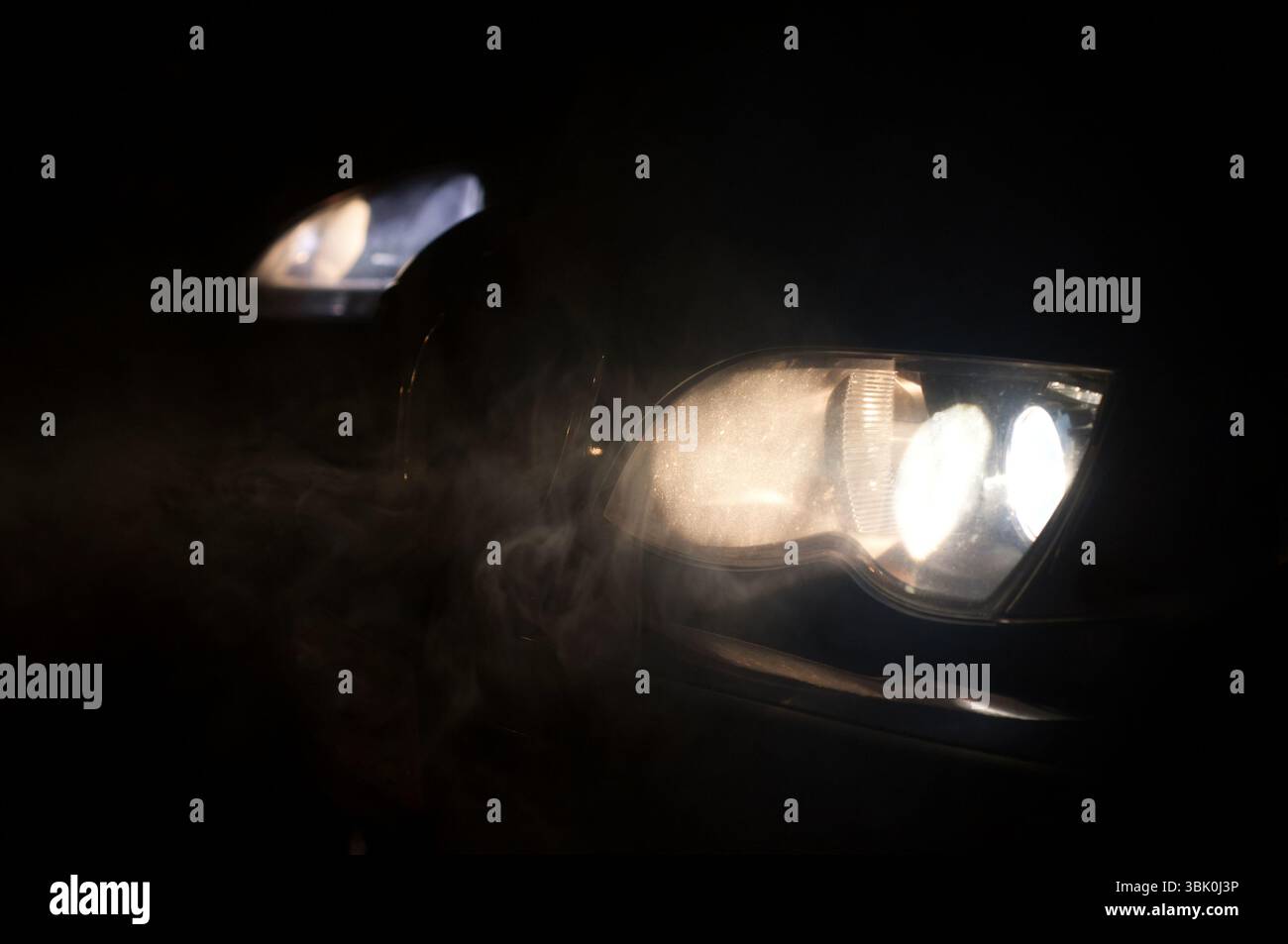 Car Headlights of a car at night Stock Photo