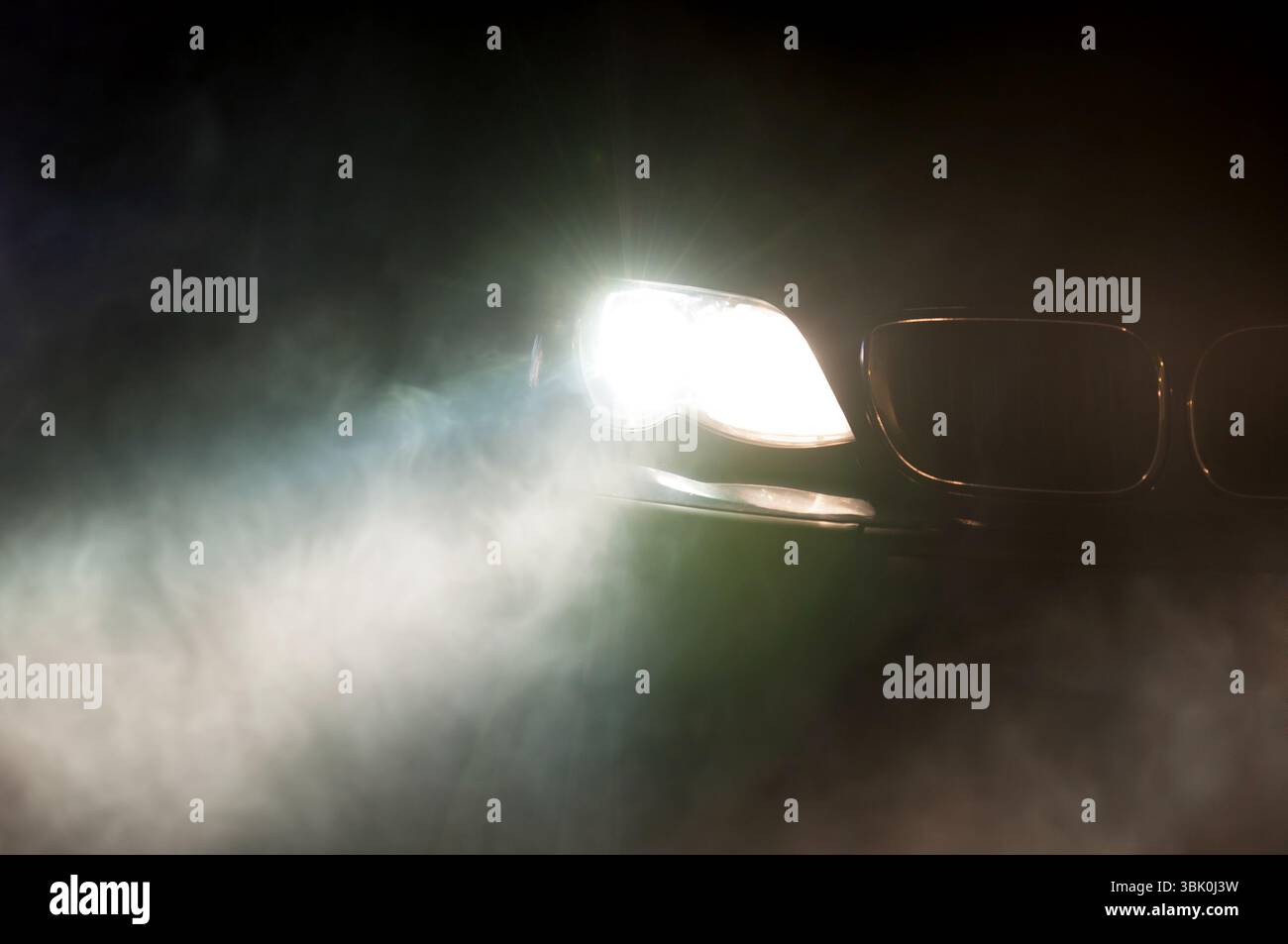 Car Headlights of a car at night Stock Photo
