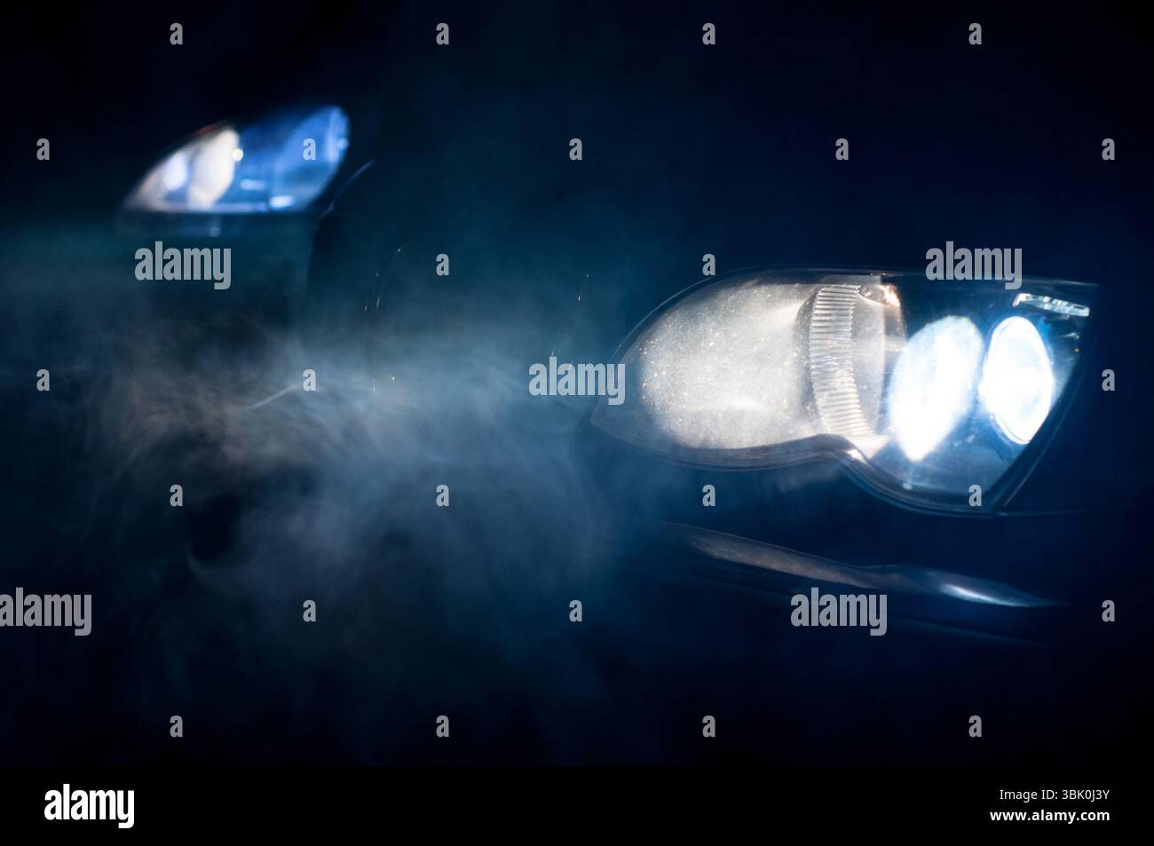 Car Headlights of a car at night Stock Photo