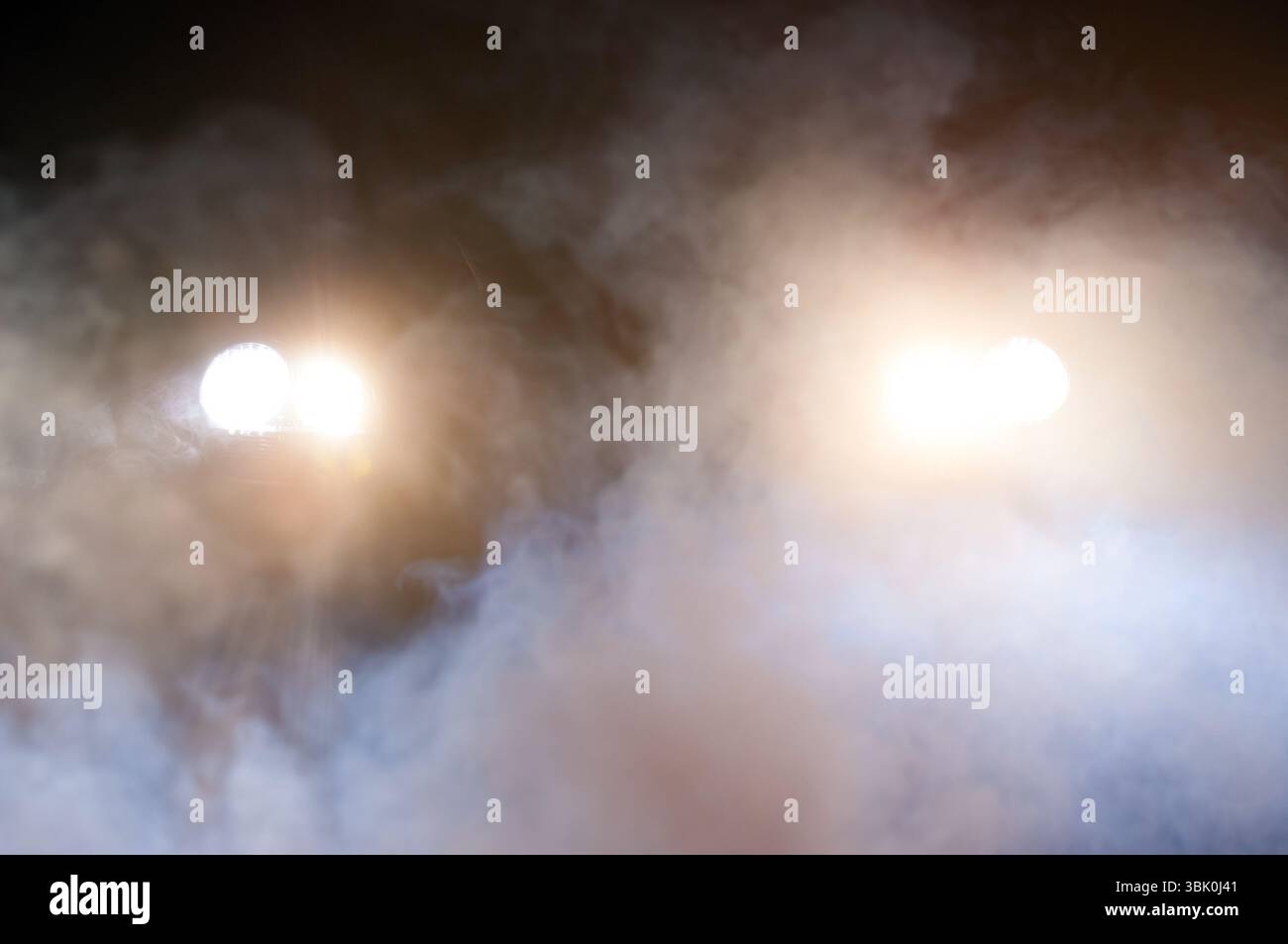 Car Headlights of a car at night Stock Photo