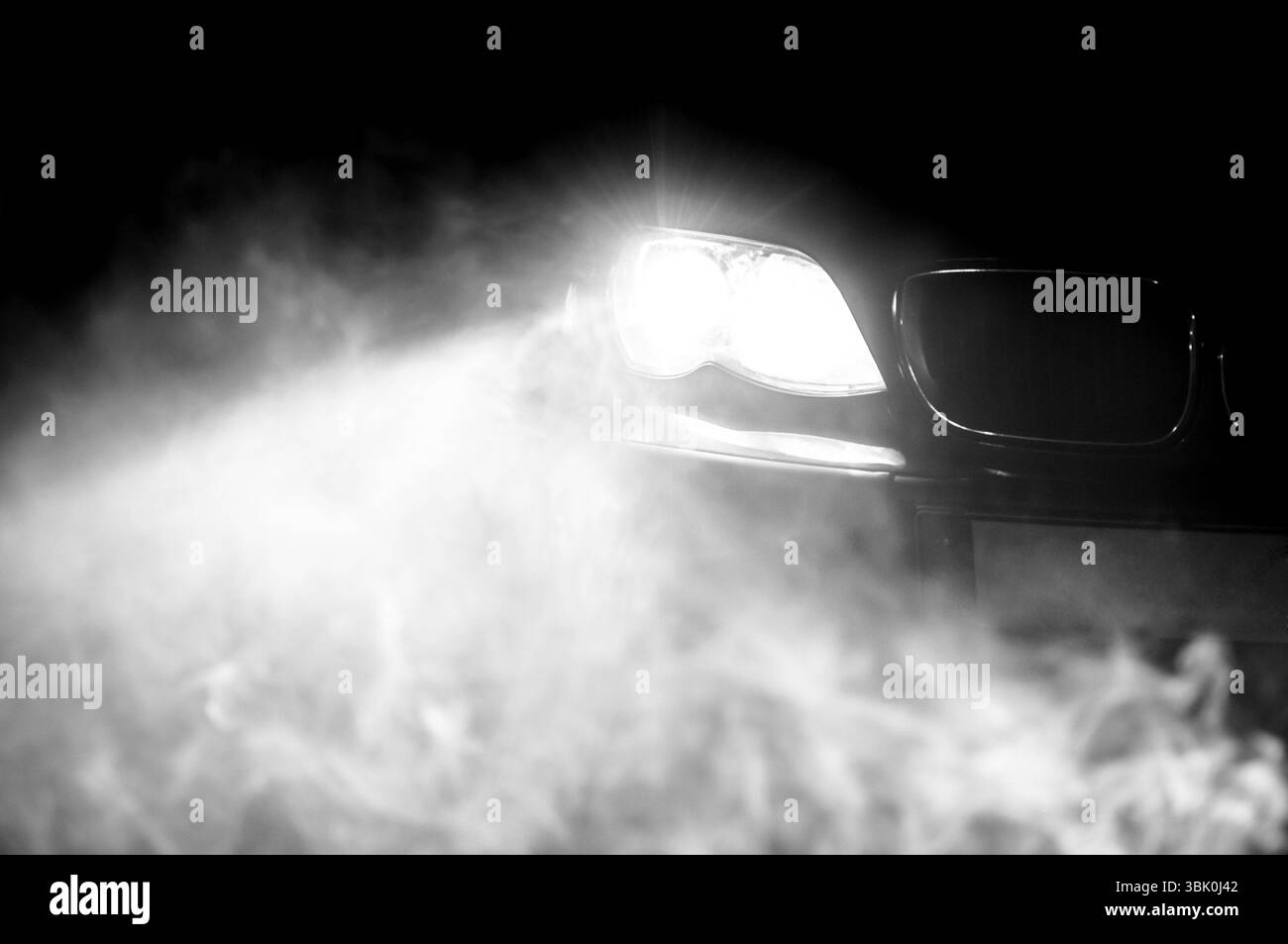 Car Headlights of a car at night Stock Photo