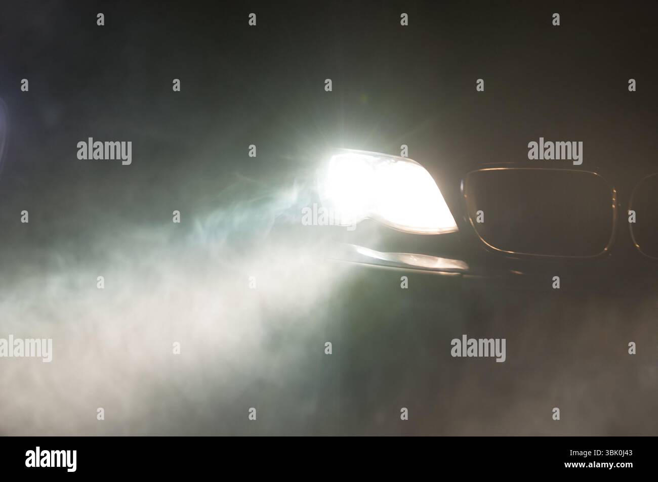 Car Headlights of a car at night Stock Photo