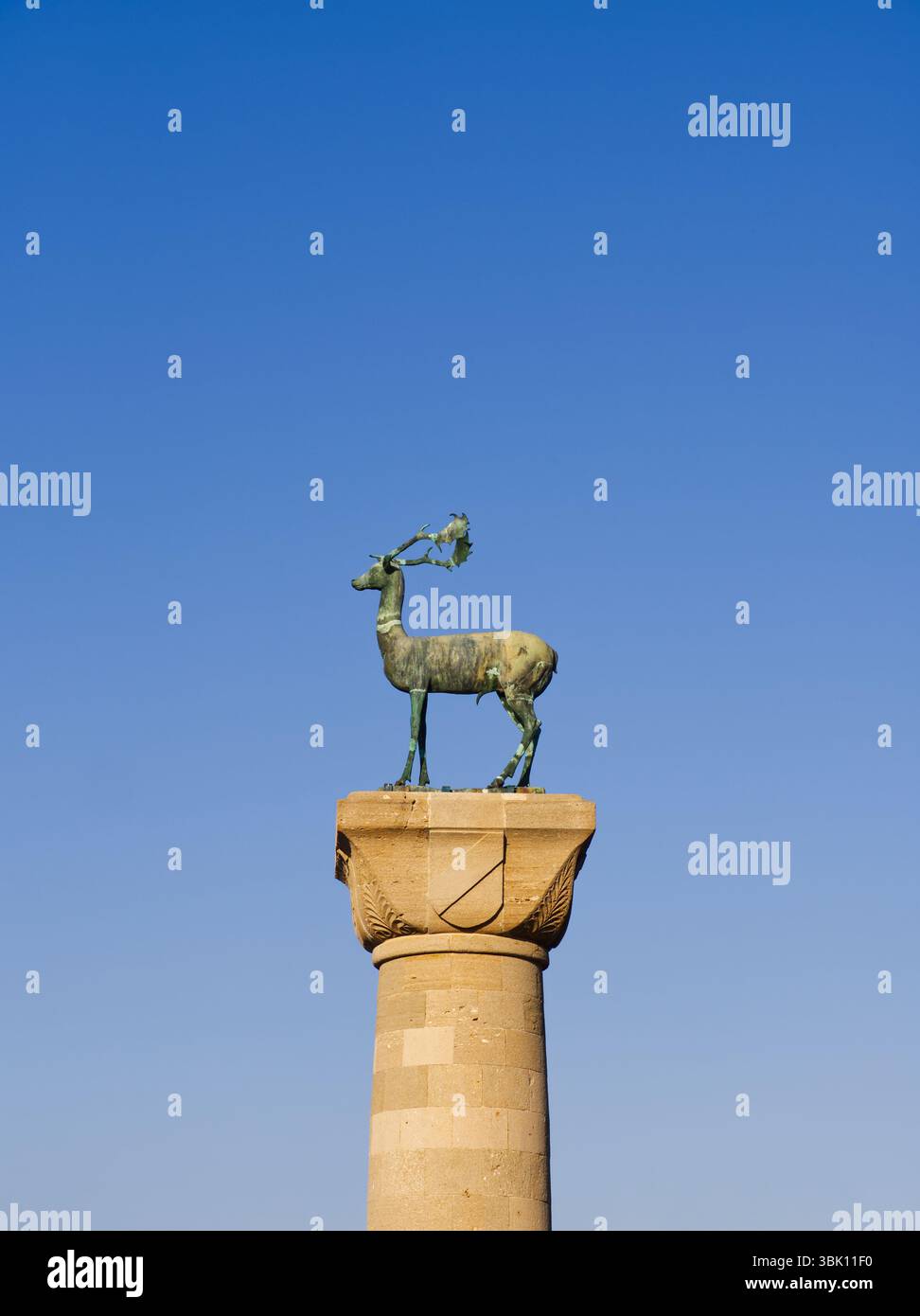 Famous bronze deer Stag statue in Rhodes port with antlers standing on ...