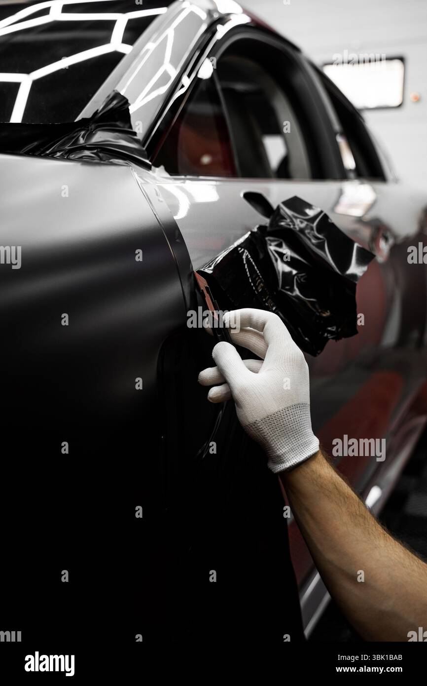 Vinyl edge cutting in detailing center. Applying wrap with precision ...
