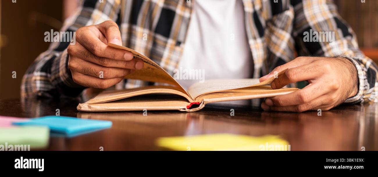 Student Guy Reading Book Learning Sitting In Library Stock Photo