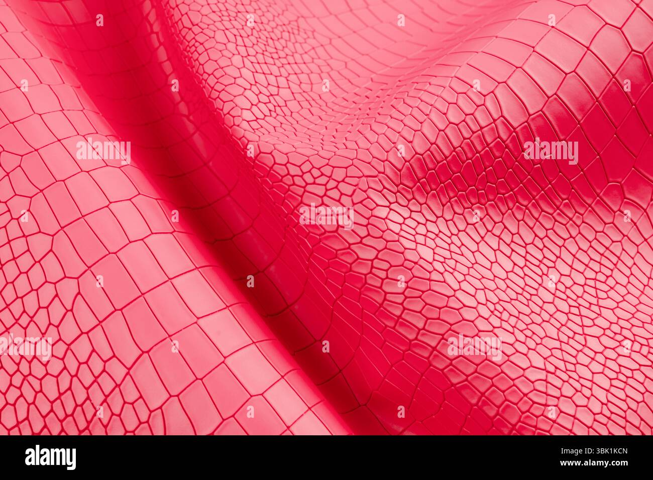 Red color artificial crocodile leather texture as background. Stock Photo