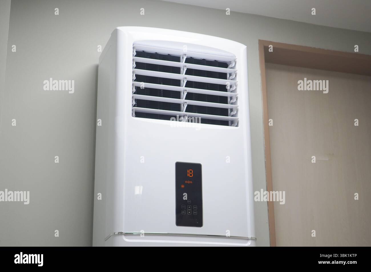 Modern air conditioner mounted on a wall for cooling Stock Photo - Alamy