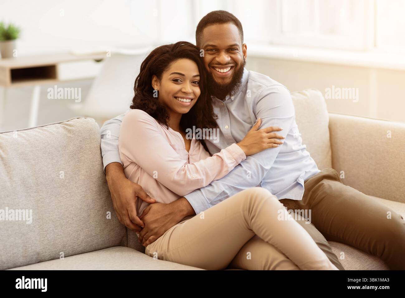 African american couple spending weekend together lying on sofa Stock ...