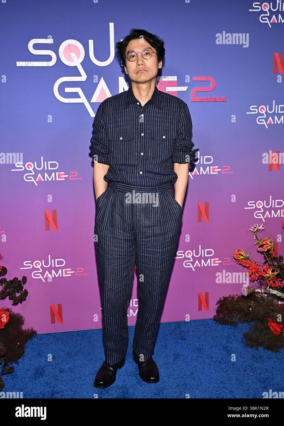 Director Hwang Dong-hyuk poses at a Netflix "Squid Game" cast photo