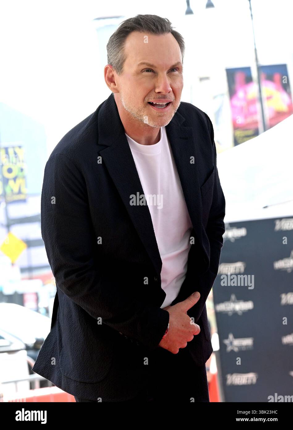 Actor Christian Slater poses for photos during the Star Ceremony On The