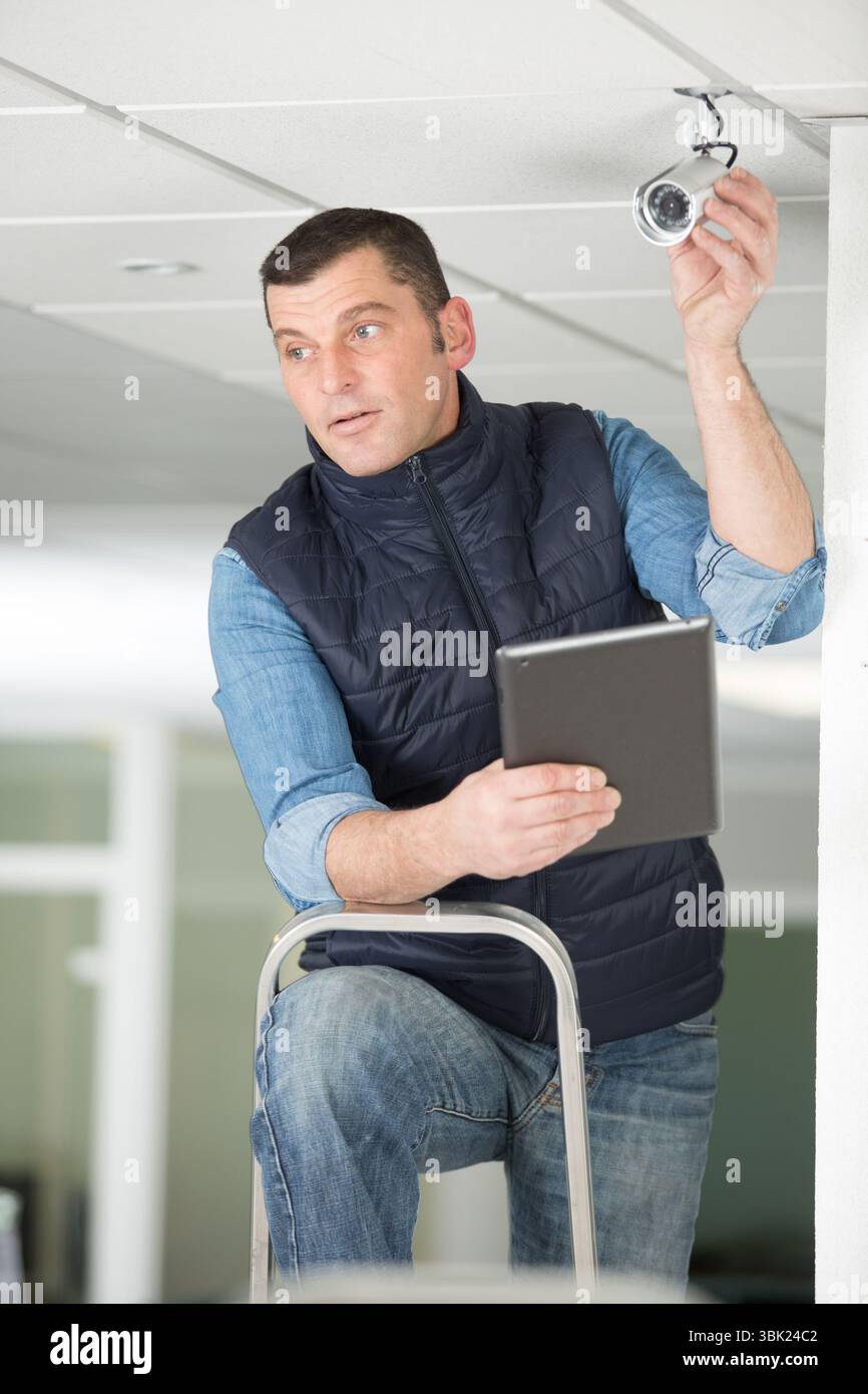 close-up of technician adjusting cctv camera Stock Photo