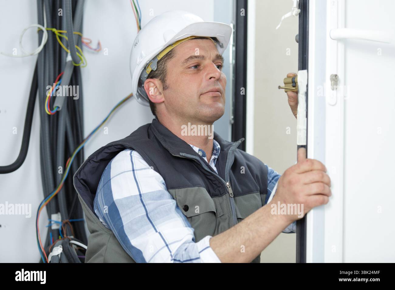 electrician installing energy saving meter Stock Photo