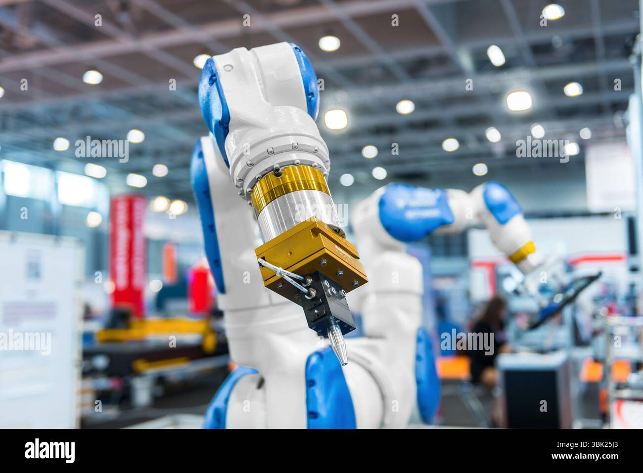 Robot arm in a factory working for the humans Stock Photo