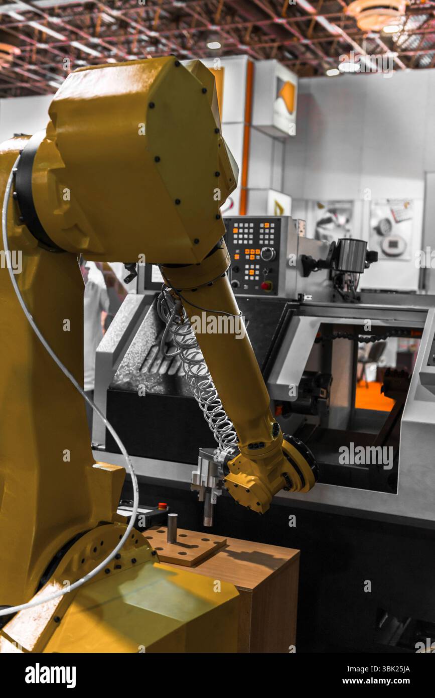 Robot arm in a factory working for the humans Stock Photo