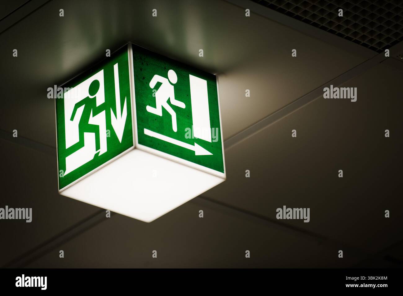 Exit sign on the wall in a building Stock Photo - Alamy