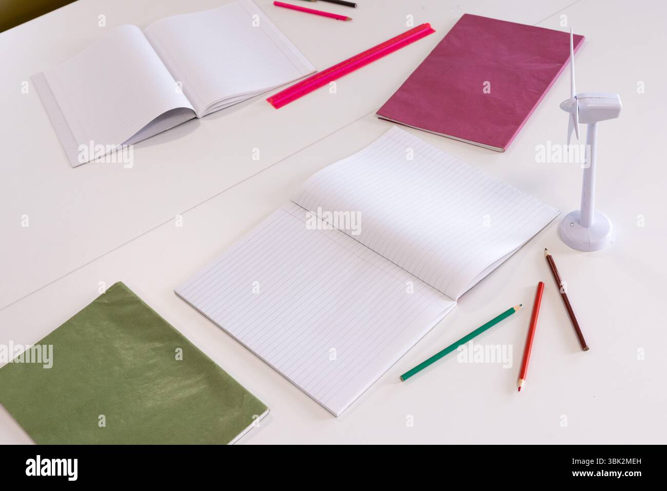 School supplies neatly arranged on desk with notebooks, pencils, and ...