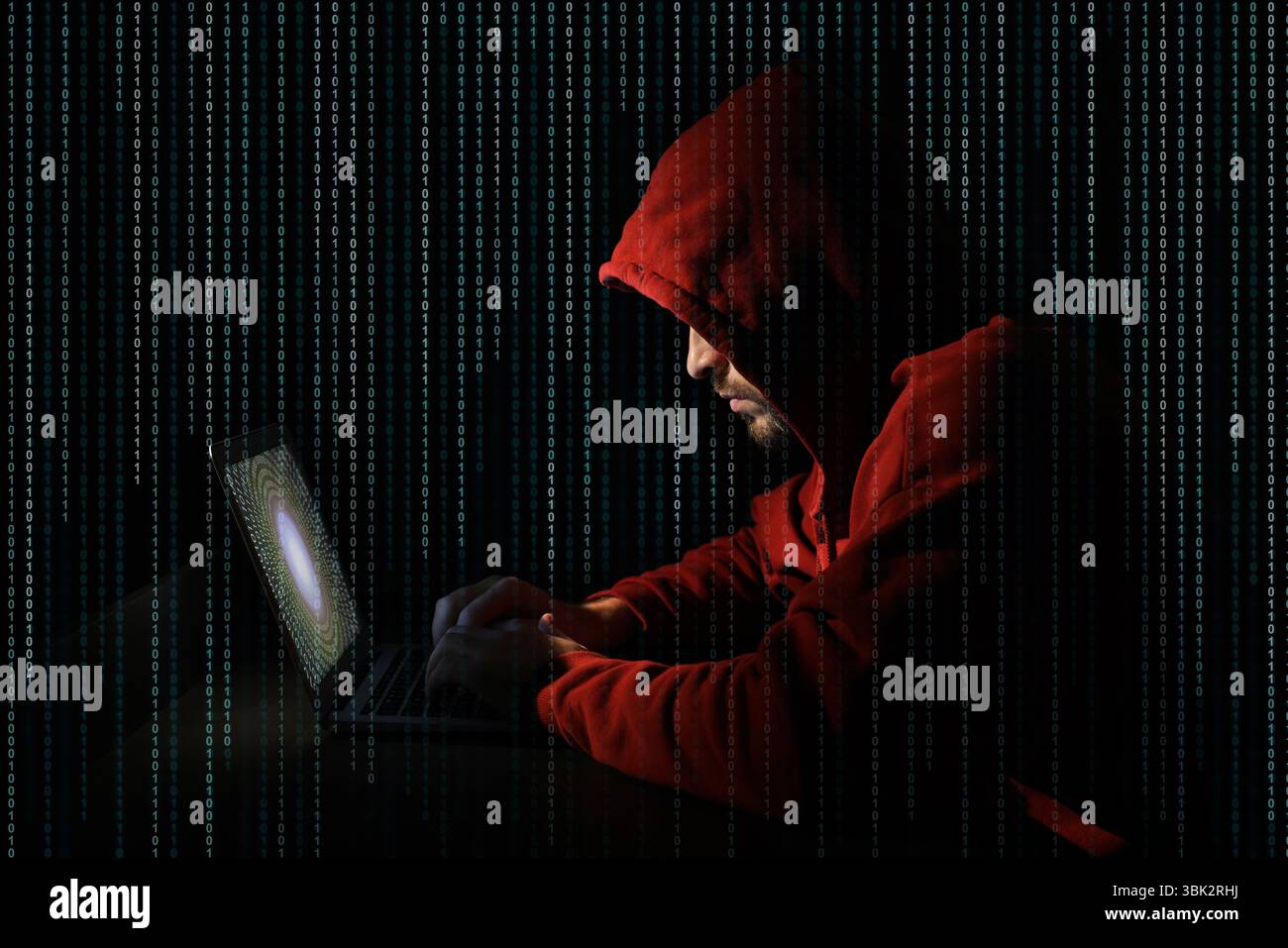Cyber attack. Hacker working on laptop against black background. Binary code around him Stock Photo