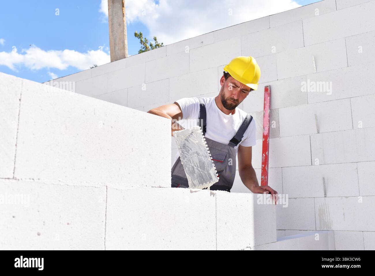 profession construction worker - work on a building site construction of a residential house Stock Photo