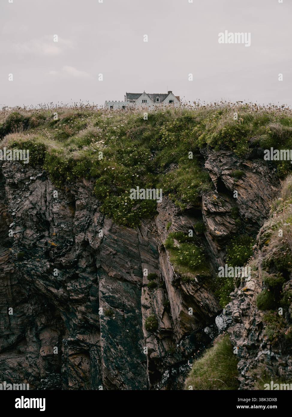 An exposed abandoned house on a rocky cliff top background Stock Photo