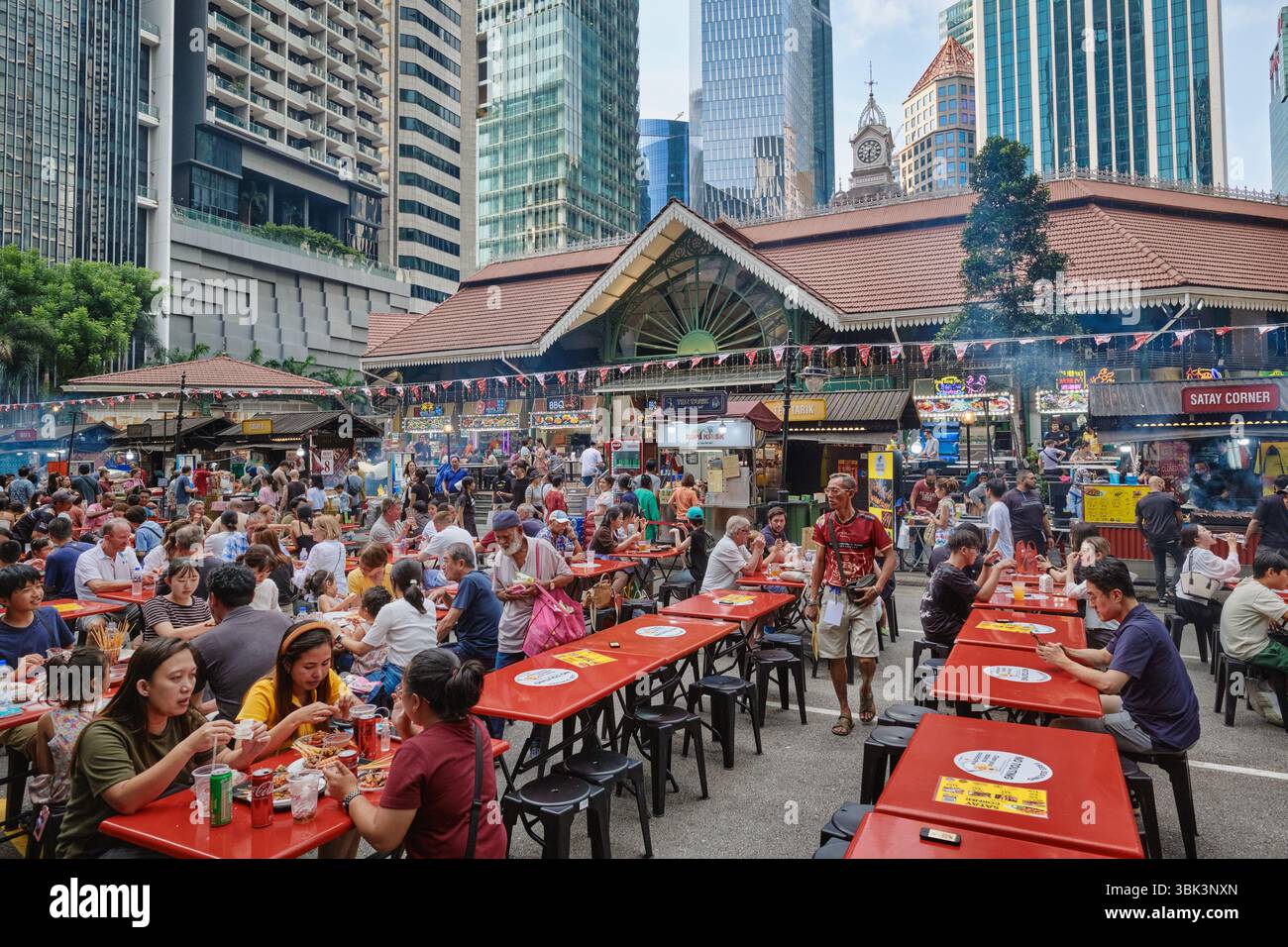 A crowd of patrons eating out in so-called Satay Street outside Lau Pa Sat hawker center, Raffles Place, Singapore, Southeast Asia Stock Photo