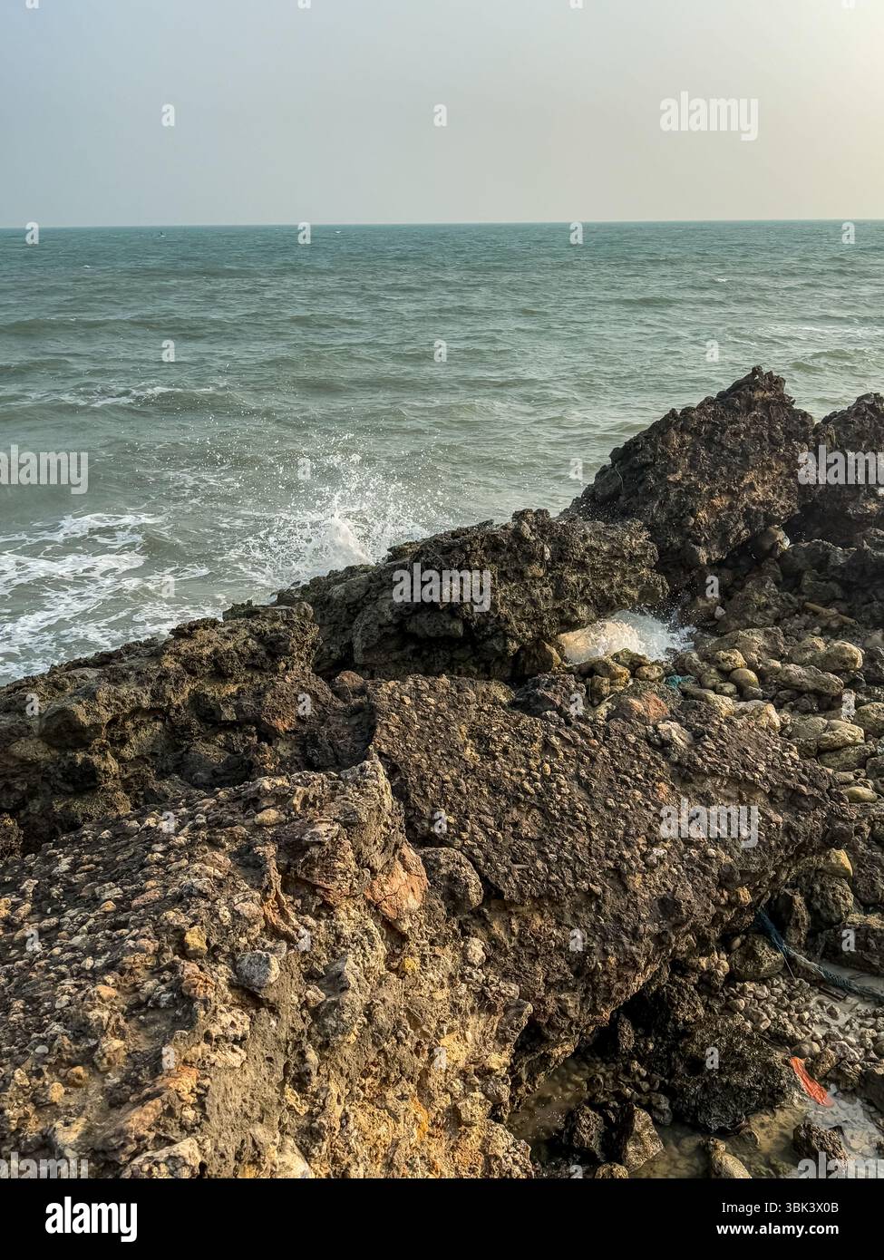 Early morning at Jaffna beach with calm sea and small waves rolling in. - Smartphone Captured Stock Image
