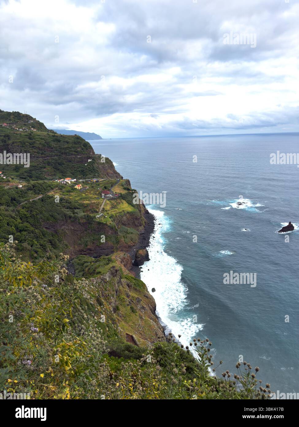 Vertical shot of coastline and ocean waves, off the rocky coast of Madeira, Portugal. Seascape with white surf - Smartphone Captured Stock Image