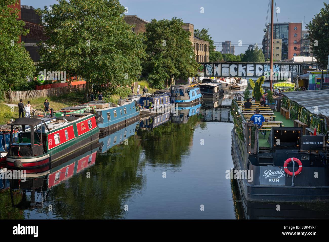 Hackney Wick, London, UK: Boats moored on the River Lee (navigation), a canal in Hackney Wick, East London. Walk along the towpath and stop in a bar Stock Photo