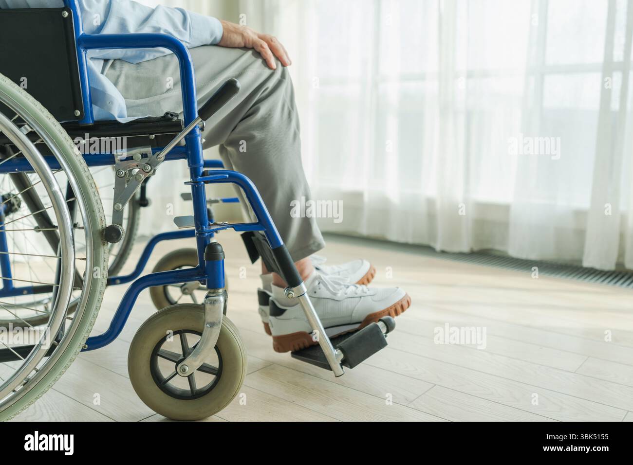 Visual Reference: Senior Man Sitting In Wheelchair Near Window In Retirement Hospital
