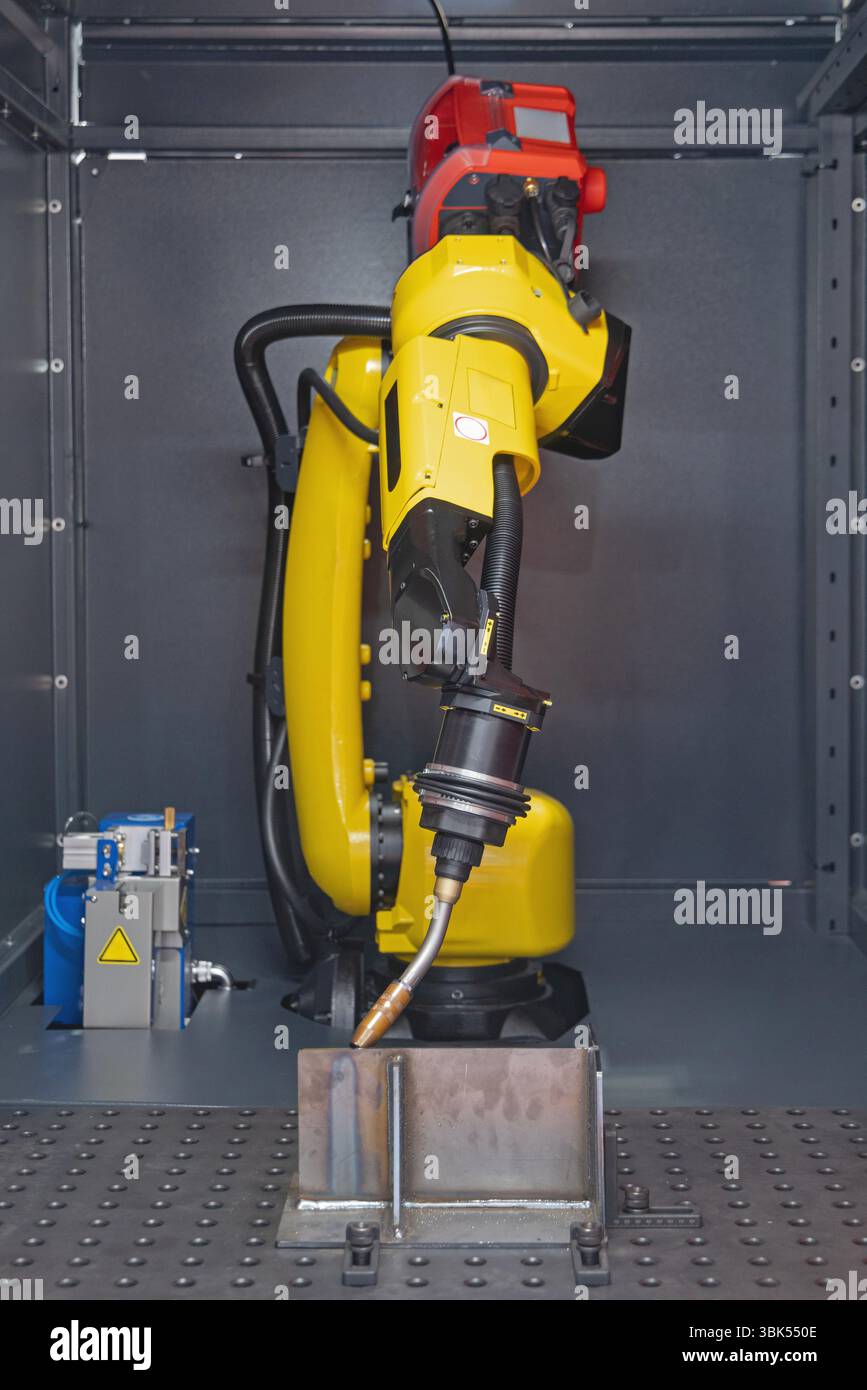 Automatic Welding Torch Robot Arm Metal Beam Workshop Stock Photo