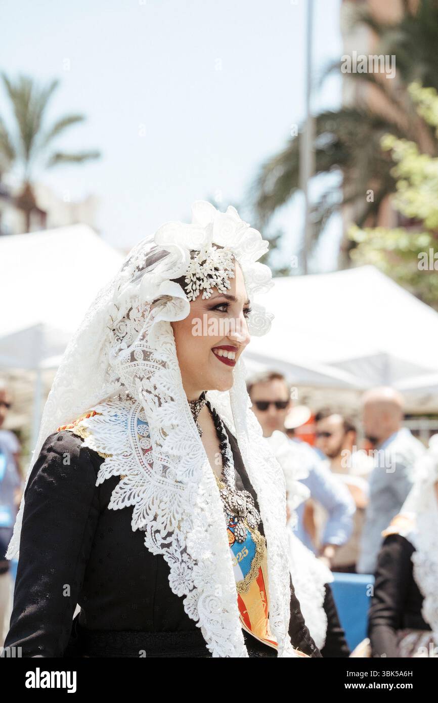 A woman dressed as a fallera during the first mascletá for the bonfires ...