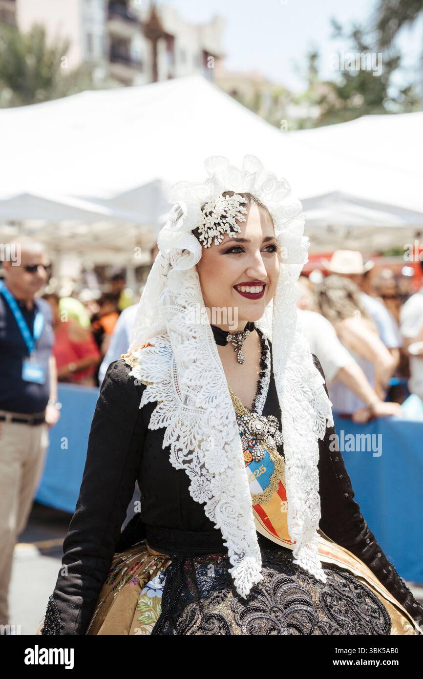 A woman dressed as a fallera during the first mascletá for the bonfires ...