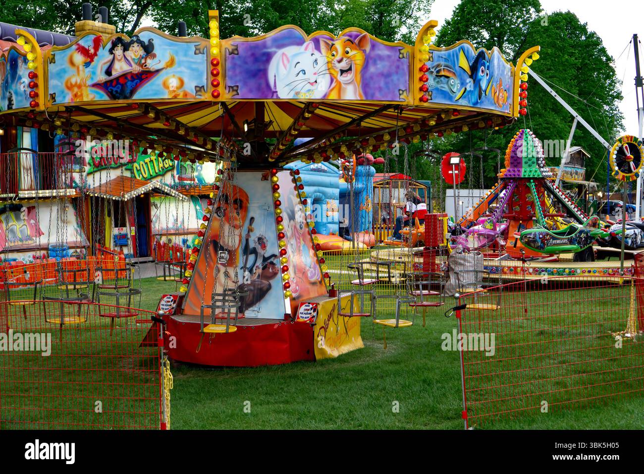 A colorful funfair scene with rides, a carousel, and other attractions ...