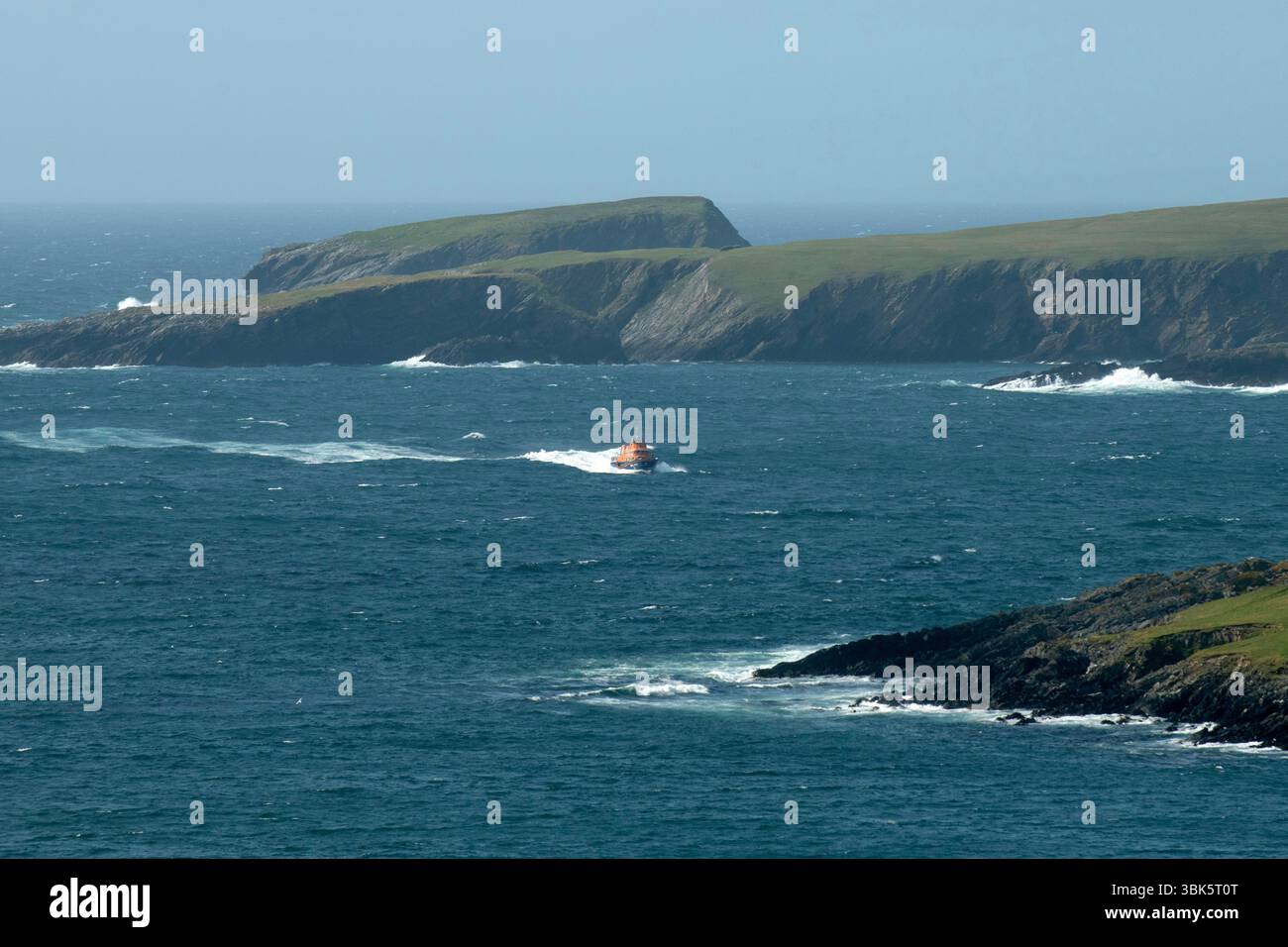 Shetland, Scotland, 18th June 2025 – Emergency response off Shetland coast – The Sumburgh coastguard rescue helicopter and Lerwick lifeboat respond to reports of a small skiff possibly sinking off the west coast of Shetland near St Ninian’s Isle. Shetland coastguard teams are assisting in the ongoing search operation. Credit: Dave Donaldson/Alamy Live News Stock Photo