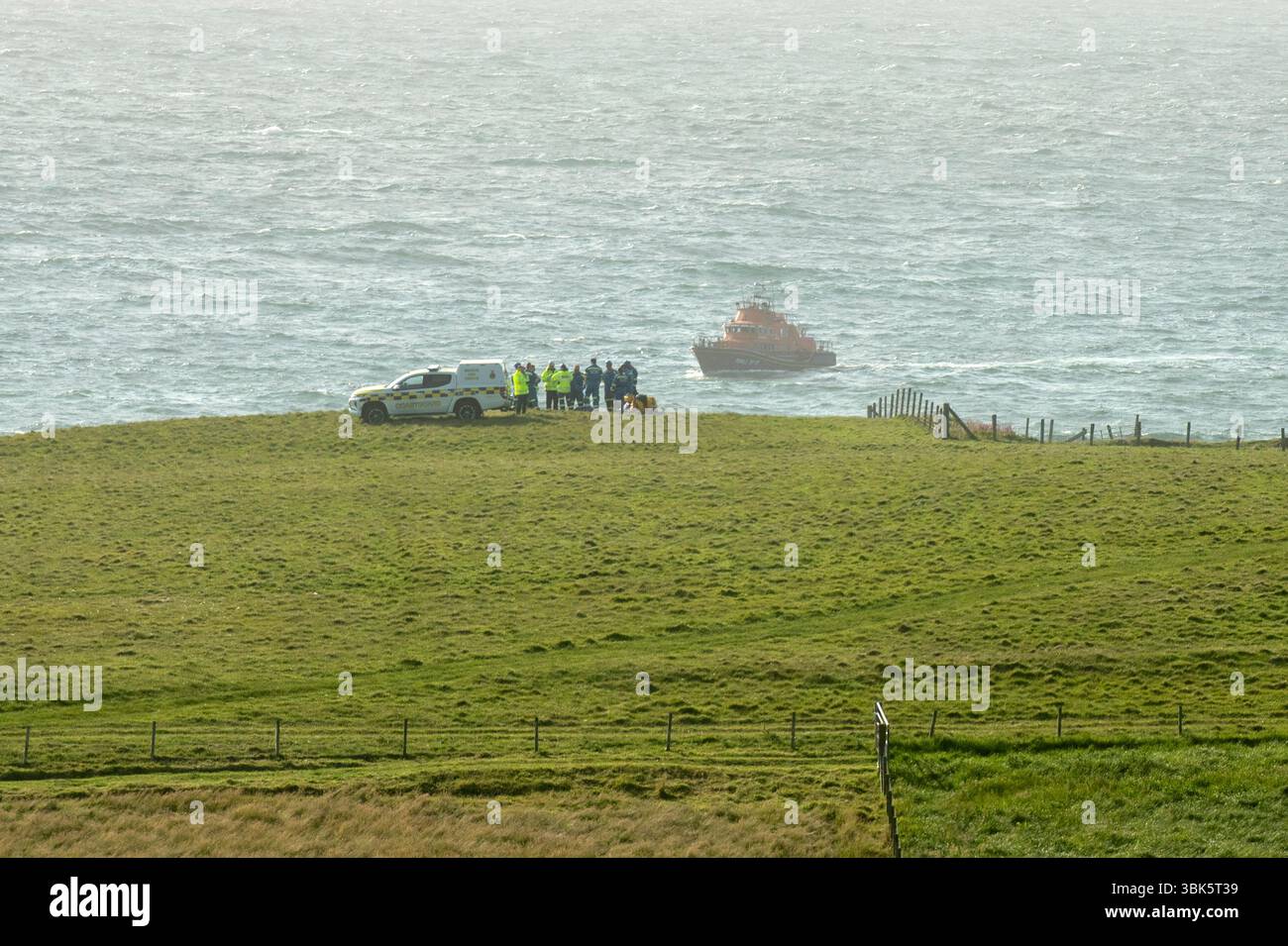 Shetland, Scotland, 18th June 2025 – Emergency response off Shetland coast – The Sumburgh coastguard rescue helicopter and Lerwick lifeboat respond to reports of a small skiff possibly sinking off the west coast of Shetland near St Ninian’s Isle. Shetland coastguard teams are assisting in the ongoing search operation. Credit: Dave Donaldson/Alamy Live News Stock Photo