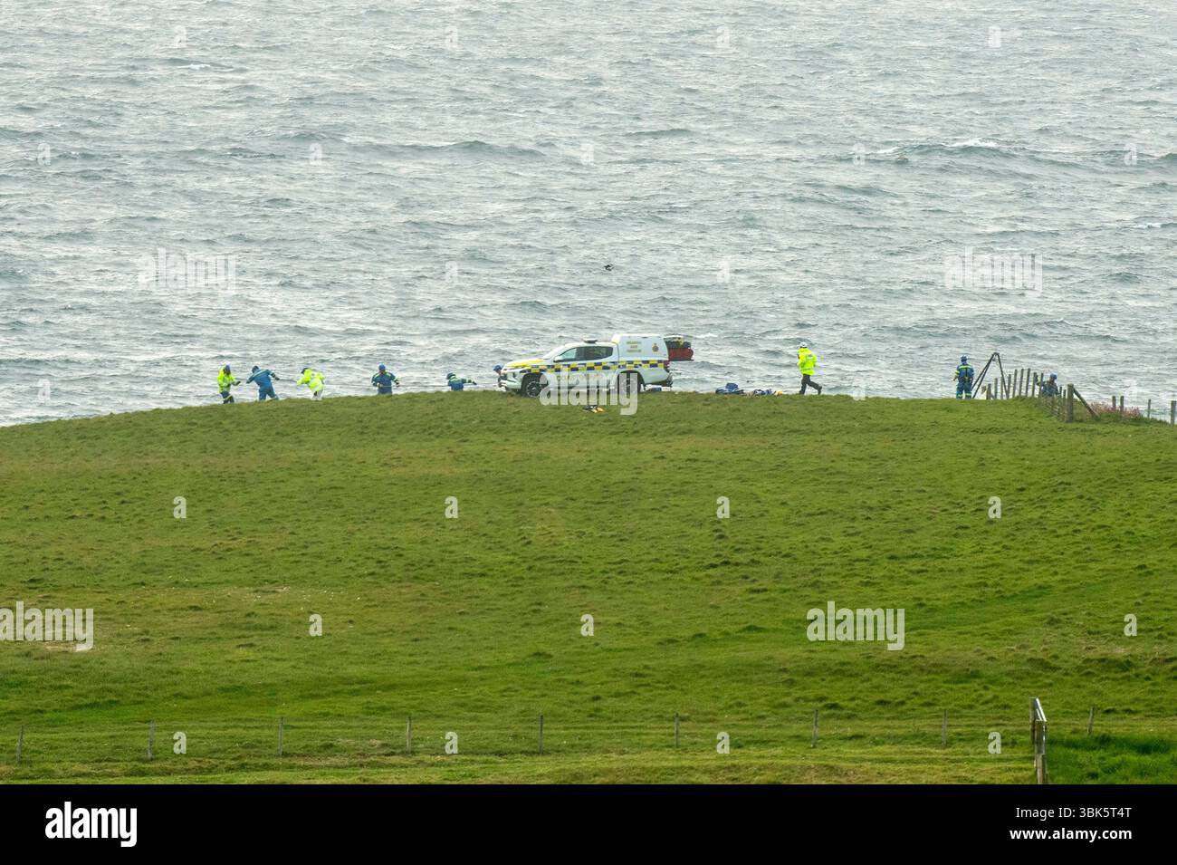 Shetland, Scotland, 18th June 2025 – Emergency response off Shetland coast – The Sumburgh coastguard rescue helicopter and Lerwick lifeboat respond to reports of a small skiff possibly sinking off the west coast of Shetland near St Ninian’s Isle. Shetland coastguard teams are assisting in the ongoing search operation. Credit: Dave Donaldson/Alamy Live News Stock Photo