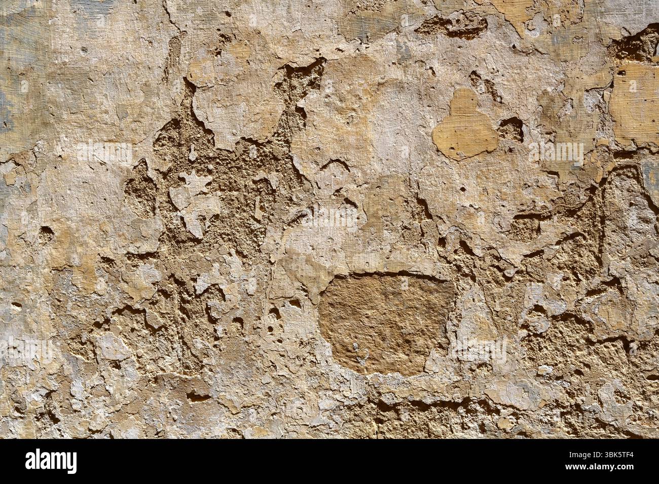 Old wall with peeling plaster or stucco for use as a background texture Stock Photo
