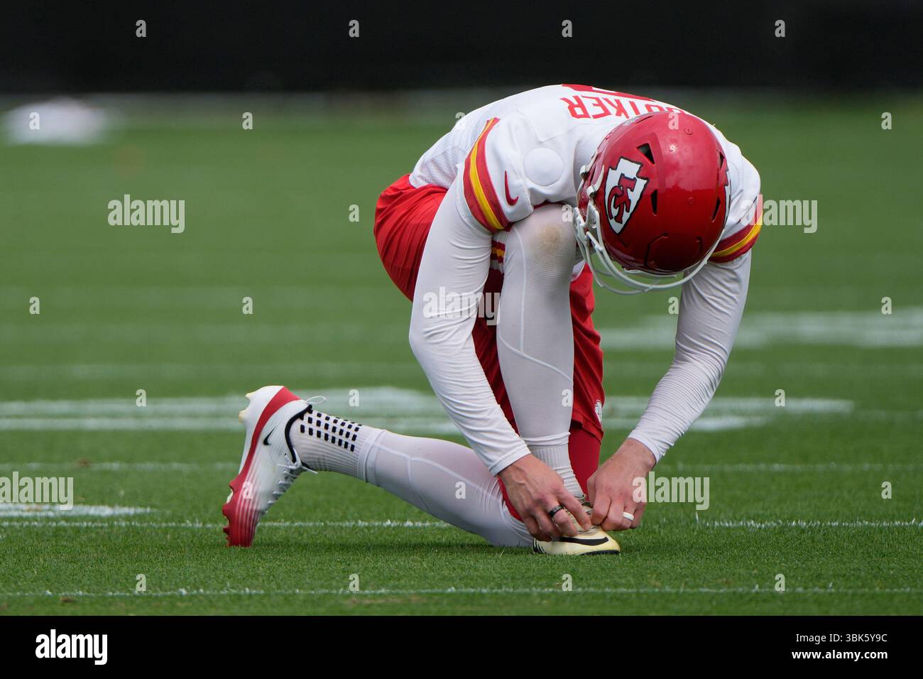 Kansas City Chiefs place kicker Harrison Butker ties his shoes before ...